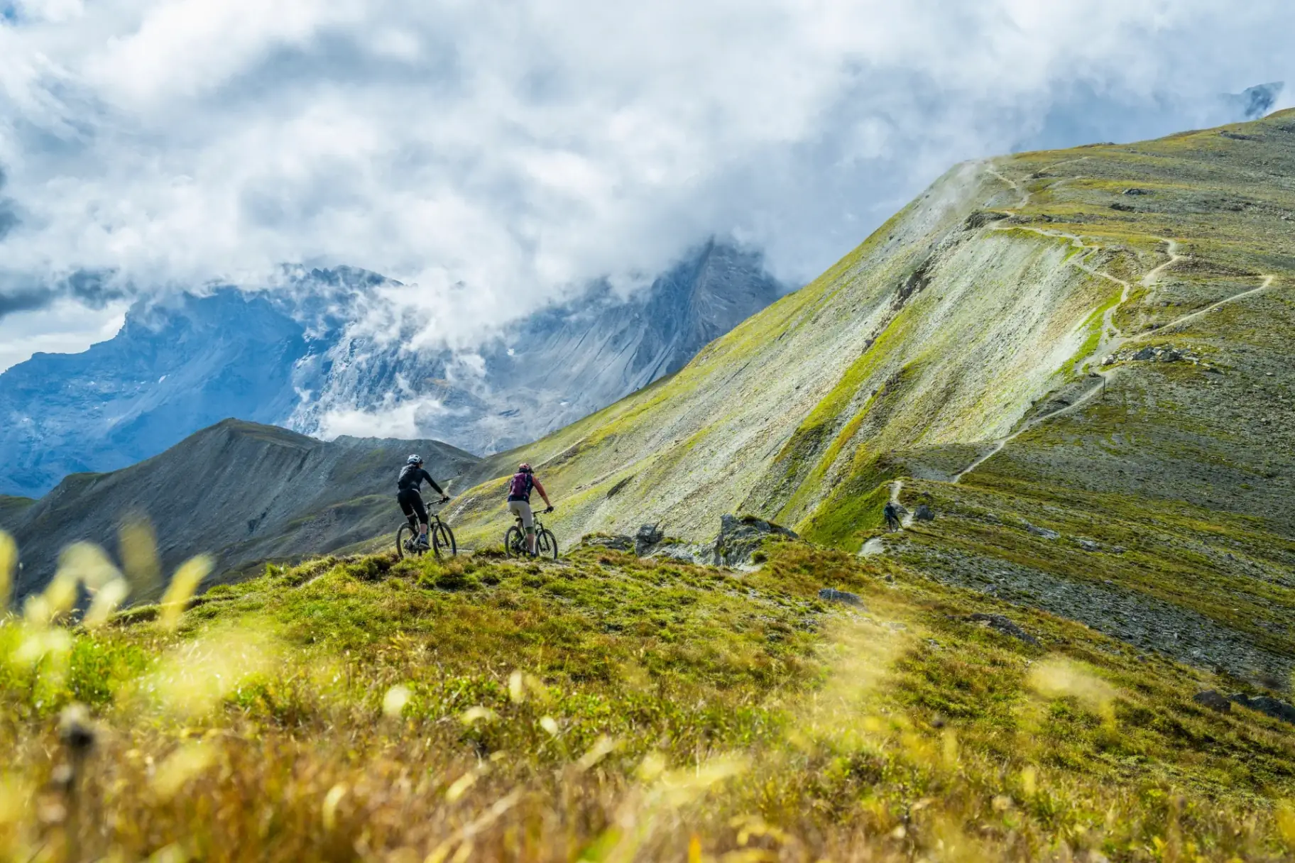 Mountain bikers on a ridge above Ischgl in summer